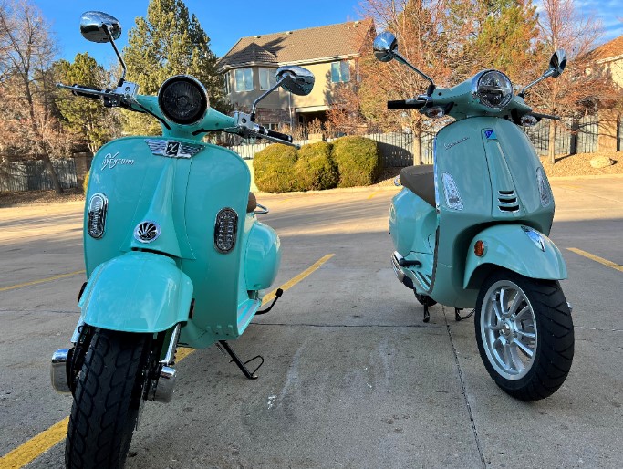 Aventura-X-Electric-Scooter-next-to-a-Vespa-50cc