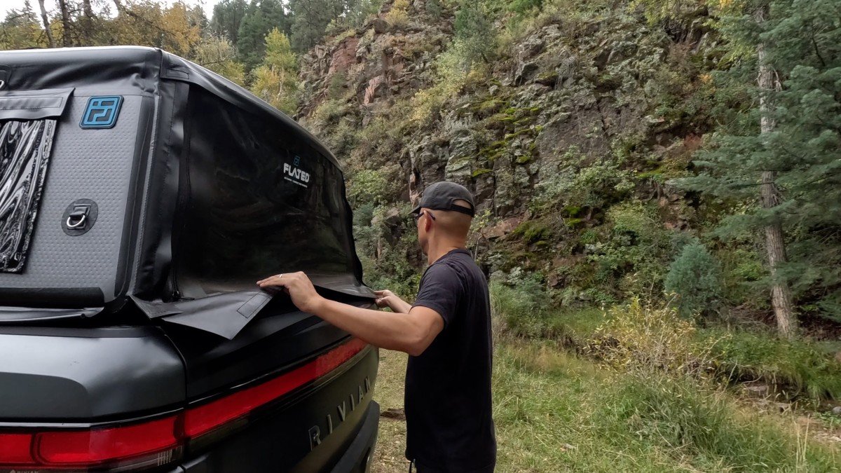 2022 Rivian R1T man opening rear window
