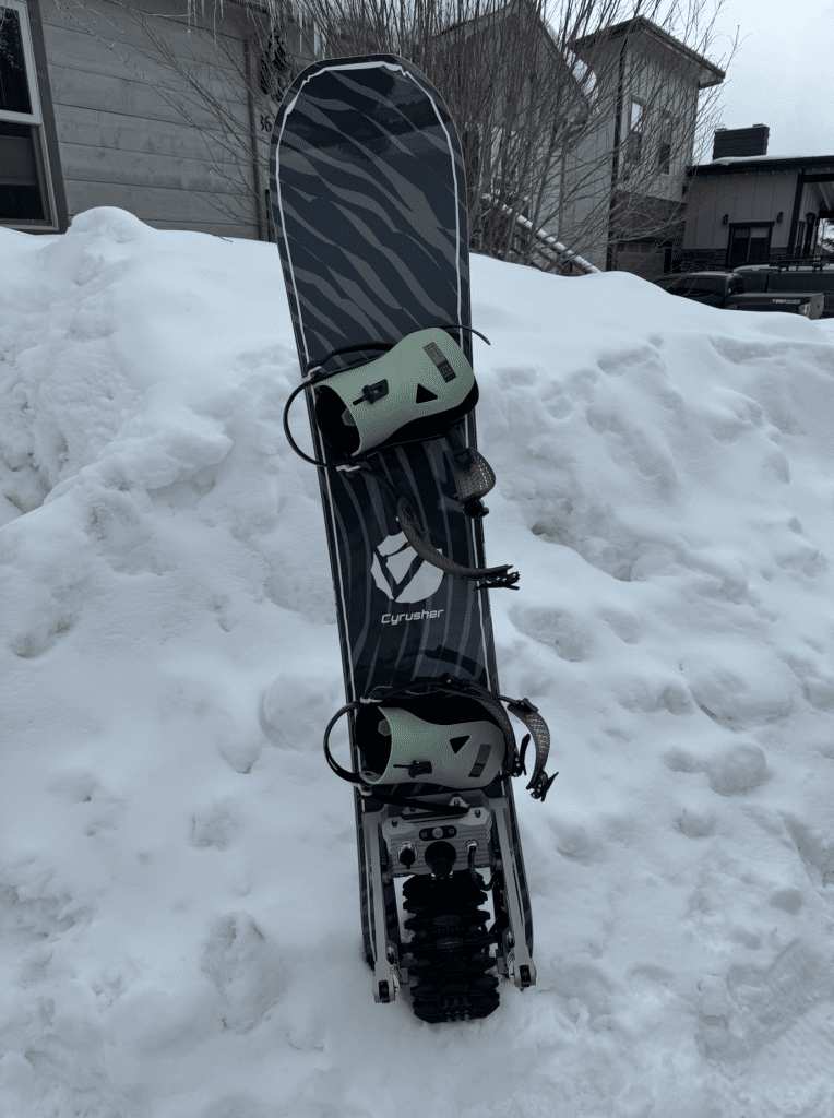 Cyrusher Ripple Electric Snowboard standing in snow review